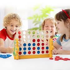Two siblings playing Connect 4 – a classic two-player game for siblings
